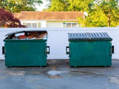 North Star Disposal crew delivering a roll-off dumpster to an Austin driveway