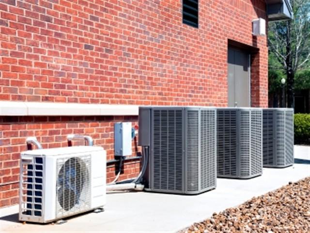 Sentry Climate Systems technician servicing an HVAC unit in Houston